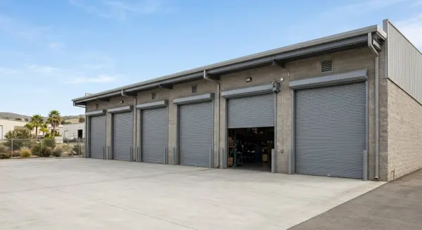 Commercial steel roll-up overhead doors on an Escondido CA warehouse – commercial door repair Escondido by 24/7 Premium Doors and Gates